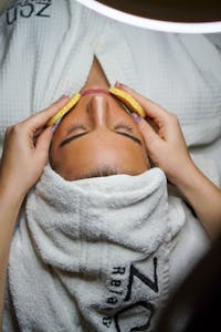 Relaxing spa treatment with facial and sponge massage in a serene environment.
